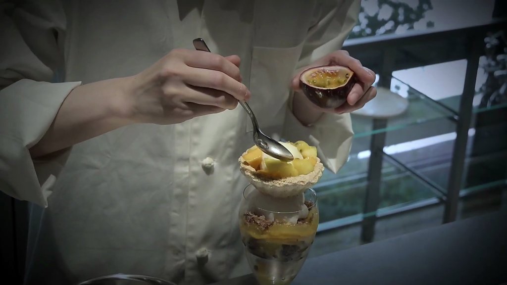 Passionfruit spooned over a mango parfait