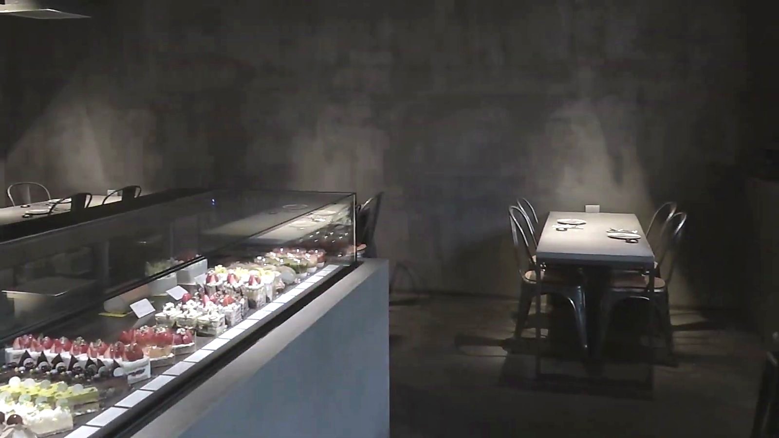 The cake cabinet, set against a wall of grey.