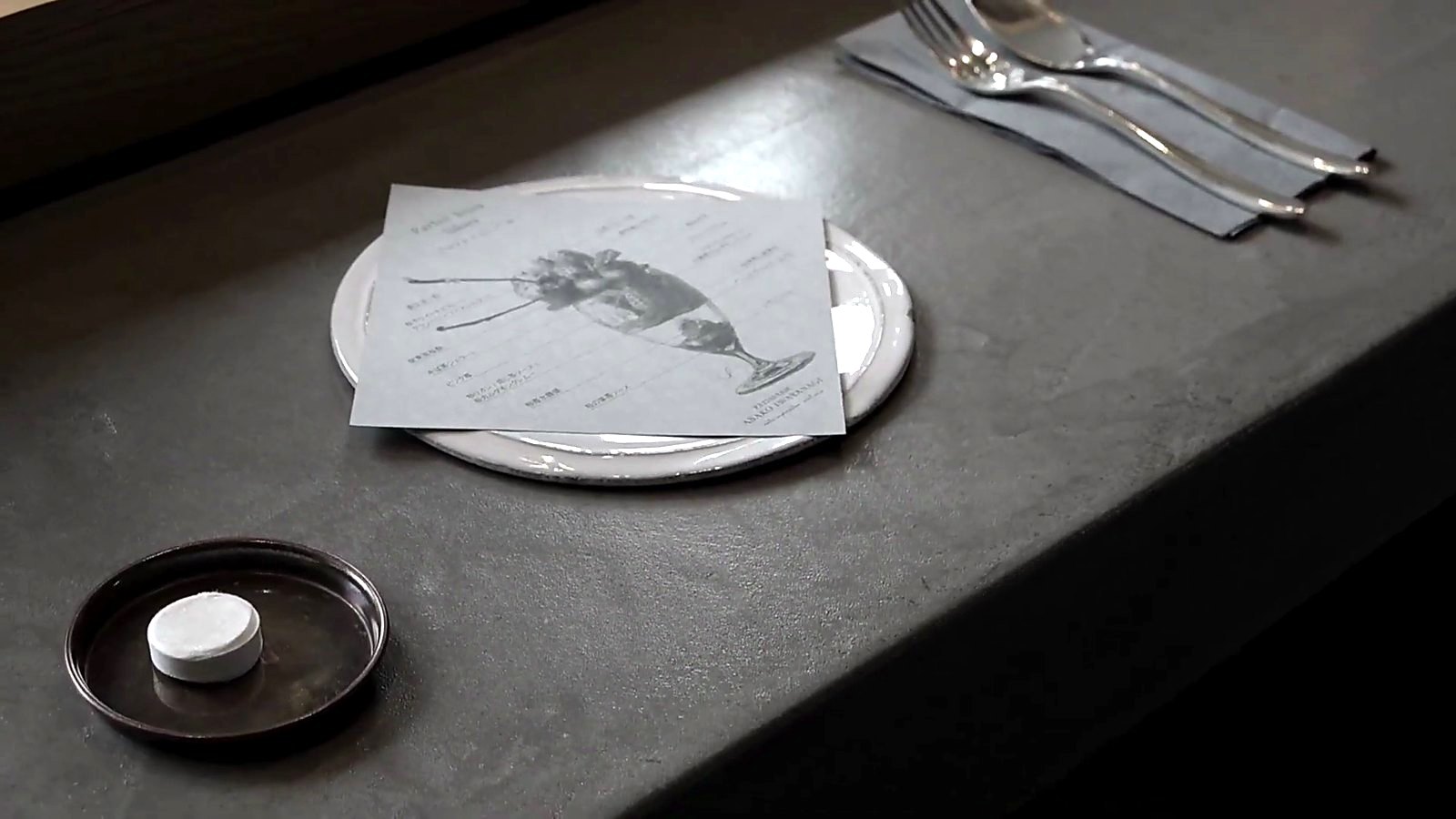 An illustrated menu card on stone.