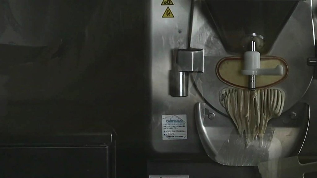 Gelato extruding in ribbons from the batch freezer