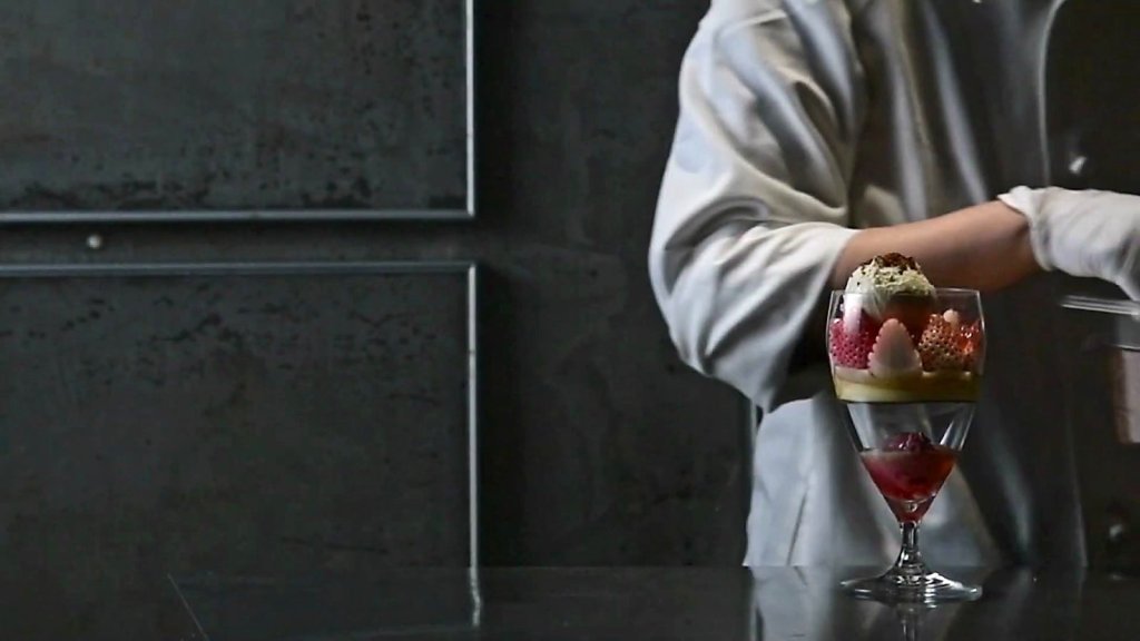 Chef assembling a strawberry parfait