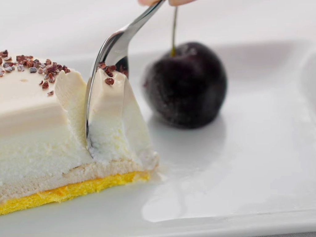 Slice of layered gelato cake with a cherry