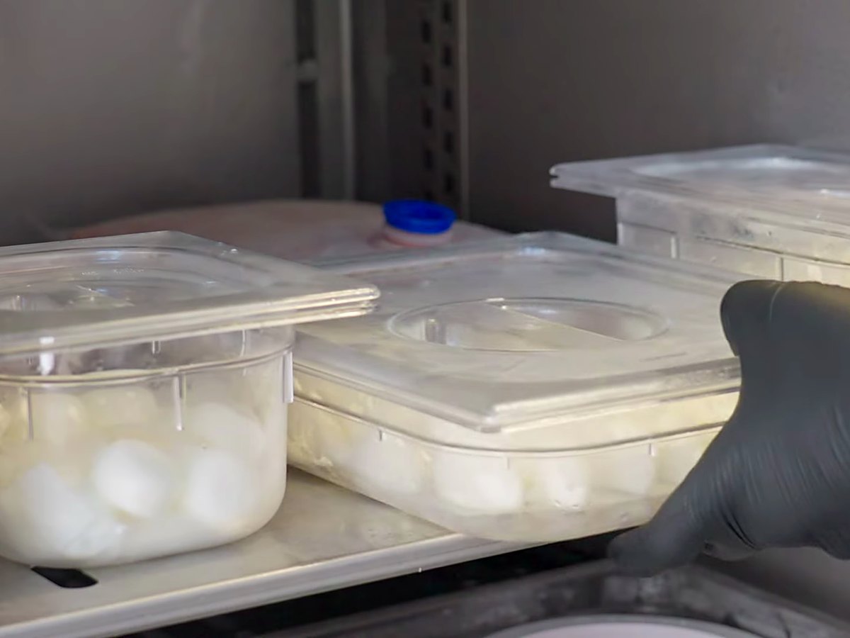 Tubs of frozen portions, stacked and ready for service.