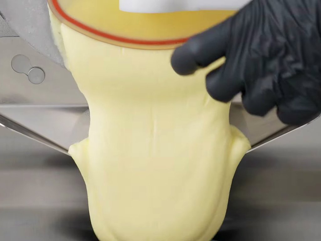 Thick ribbon of semi-dense gelato extruding from the machine
