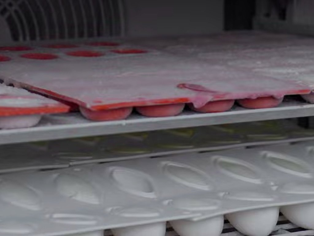 Freezer racks of filled moulds and jars