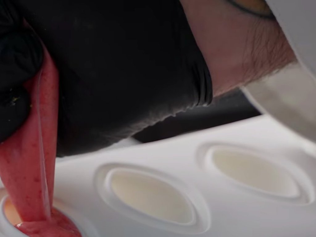 Strawberry gelato piped into silicone quenelle moulds