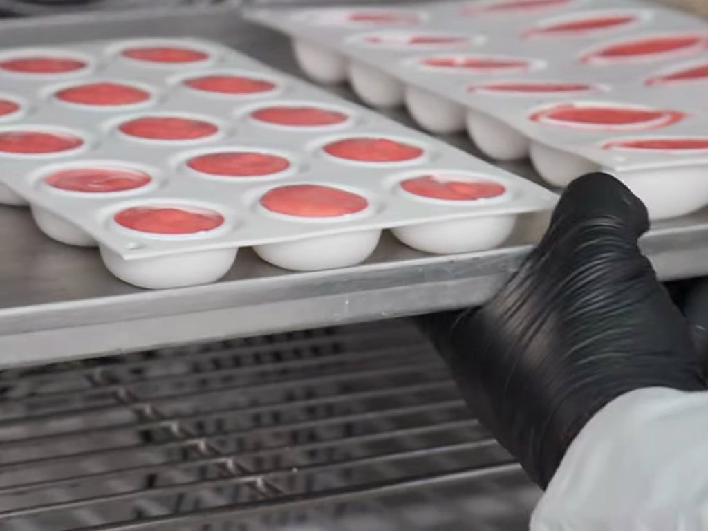 Trays of filled moulds going into a blast freezer
