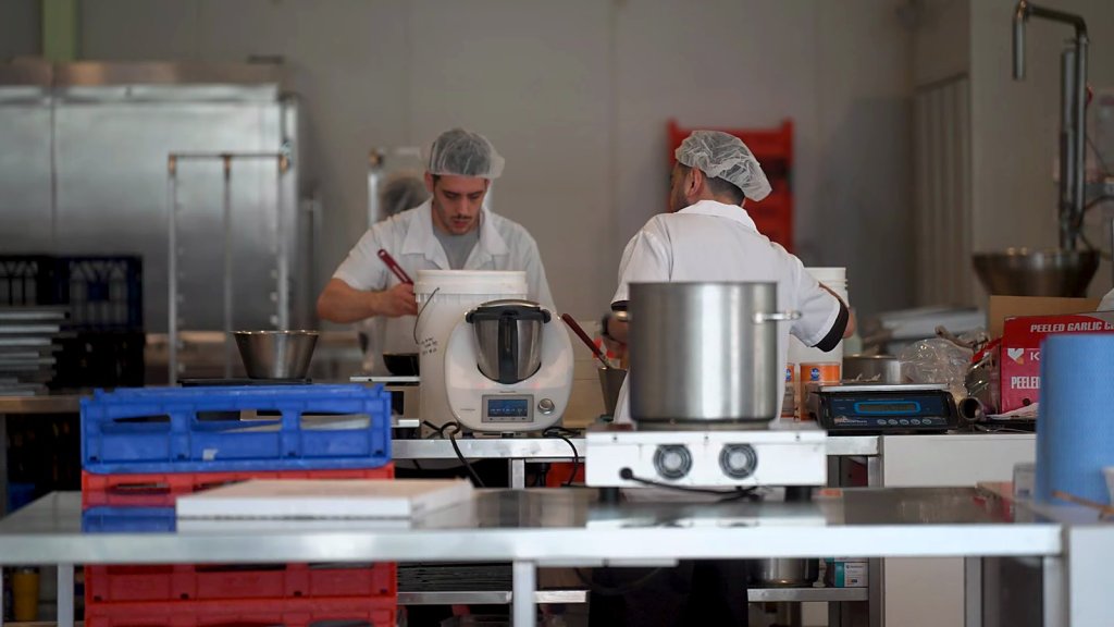 Messina staff cooking in the headquarters kitchen
