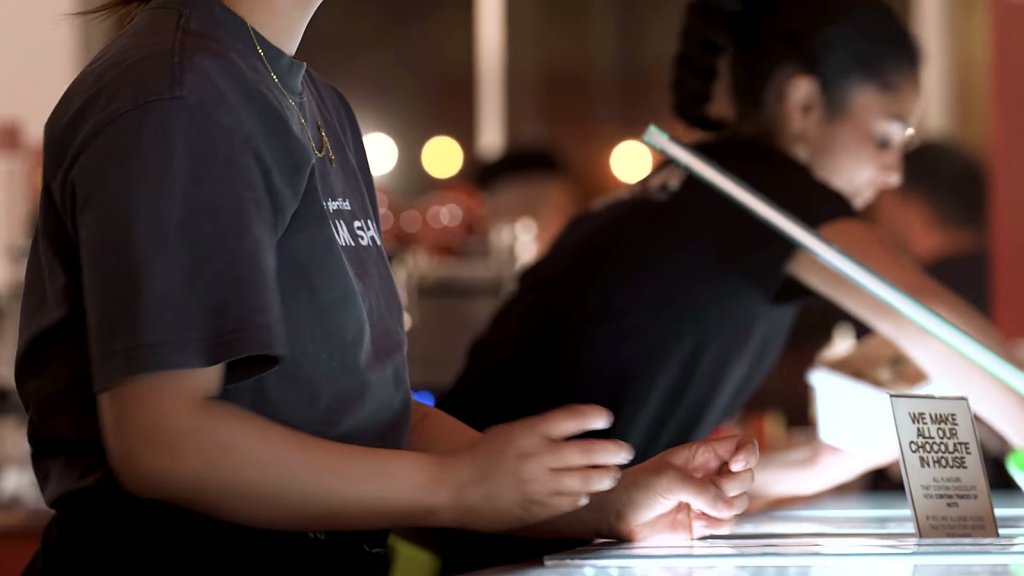 Messina staff serving at the counter at night