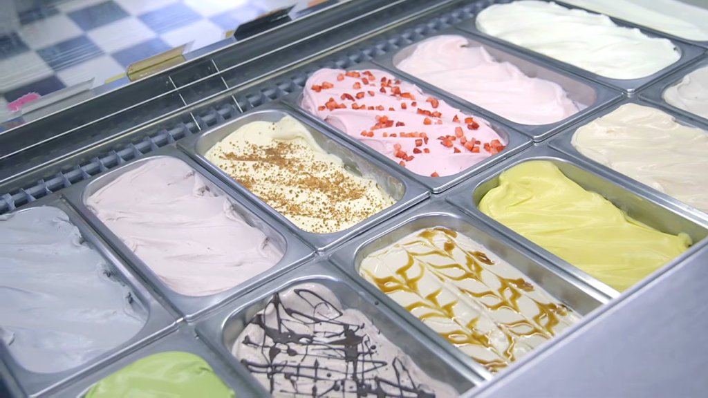 Gelato case with strawberry, caramel ripple and pistachio flavours