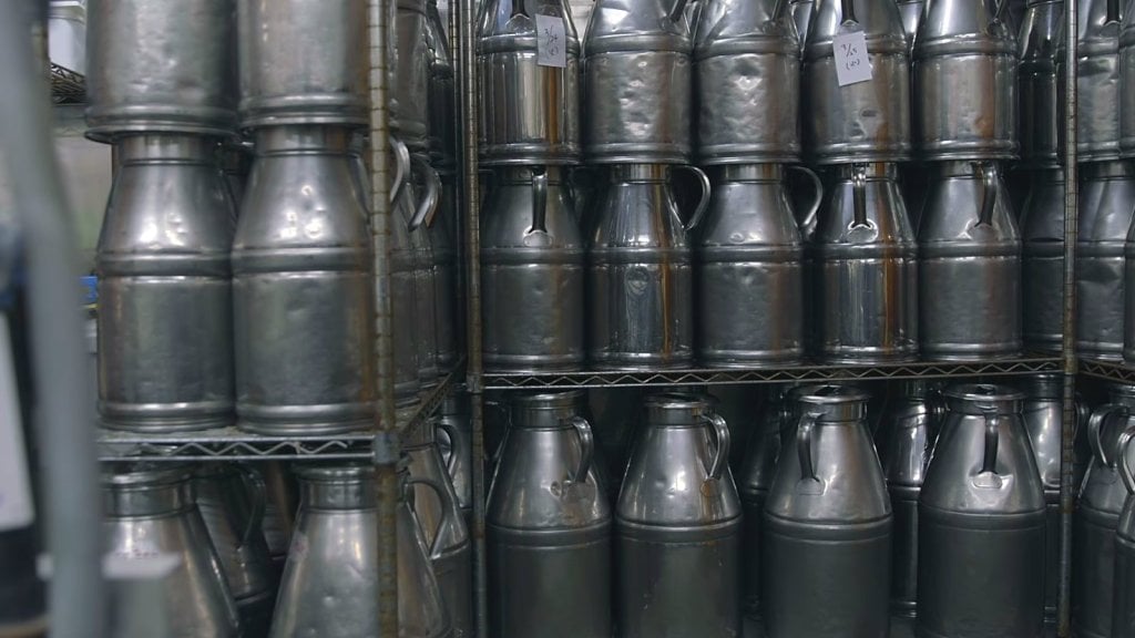 A wall of stacked milk cans