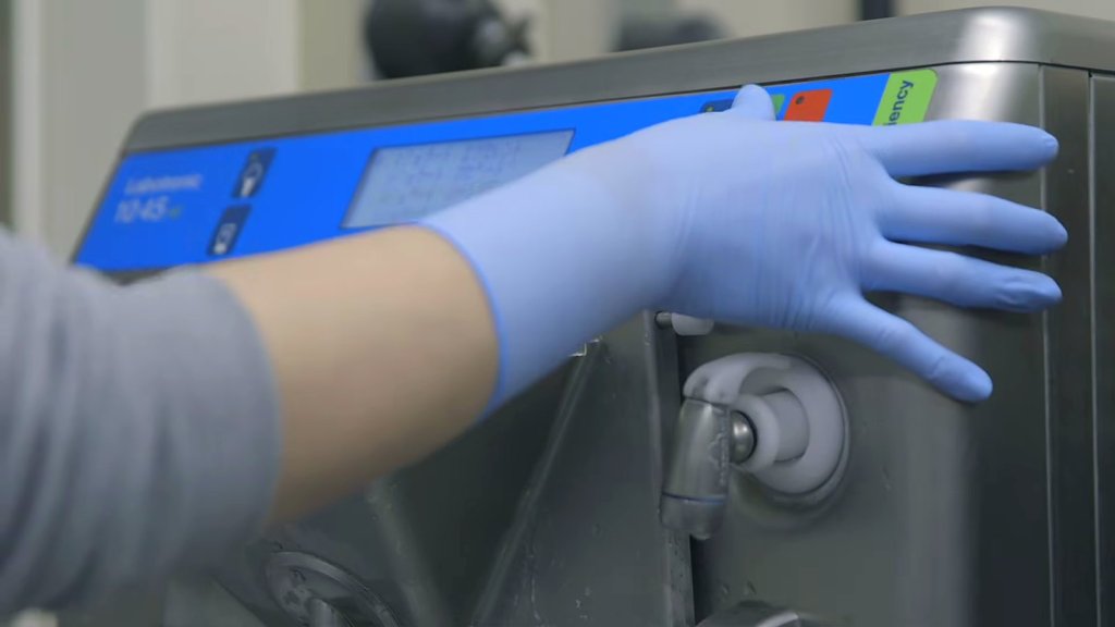 Gloved hand on a Carpigiani Labotronic control panel