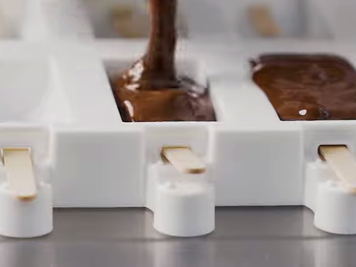 Chocolate piped into stick moulds.