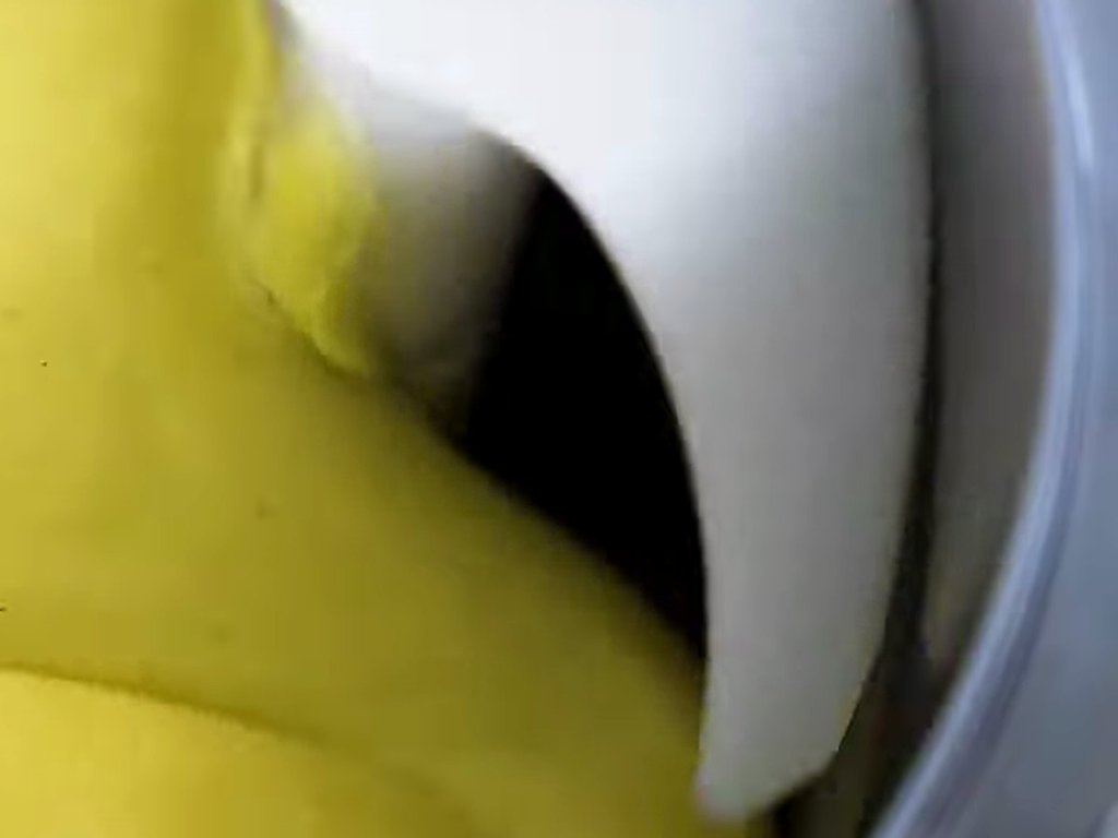 Yellow cream churning inside the cylinder