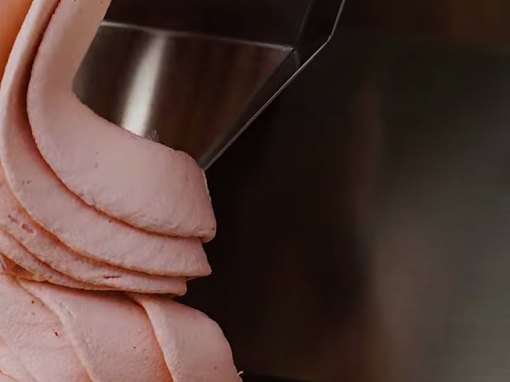 Pink gelato extruding in thick ribbons