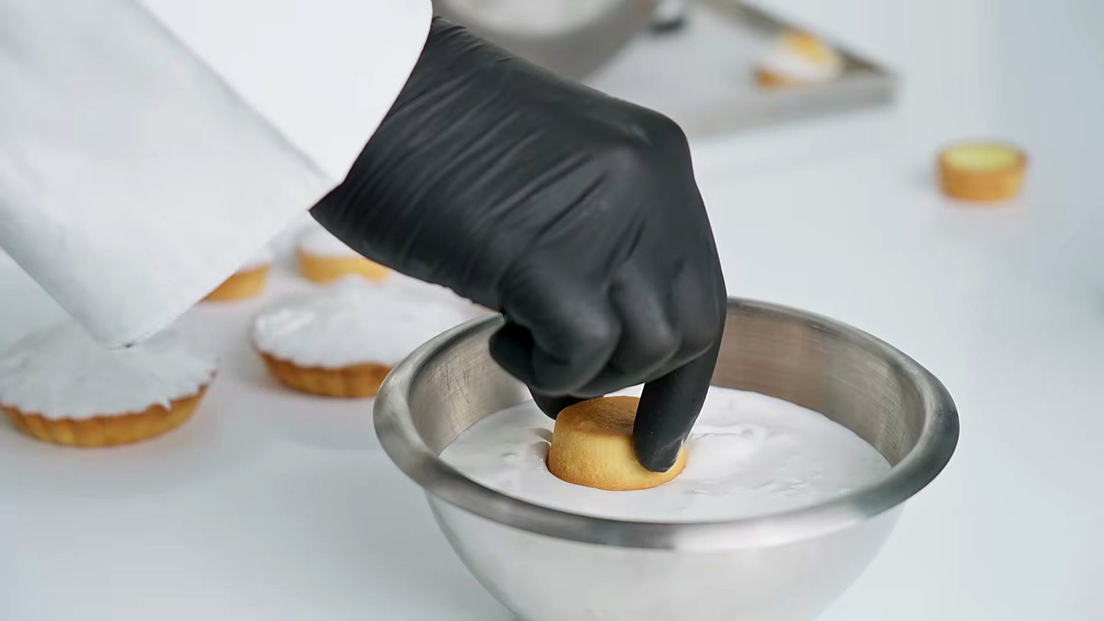 Finishing a tart by hand.