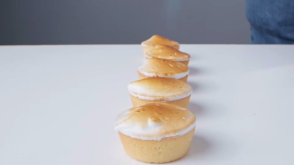 Tower of small tarts on a white bench