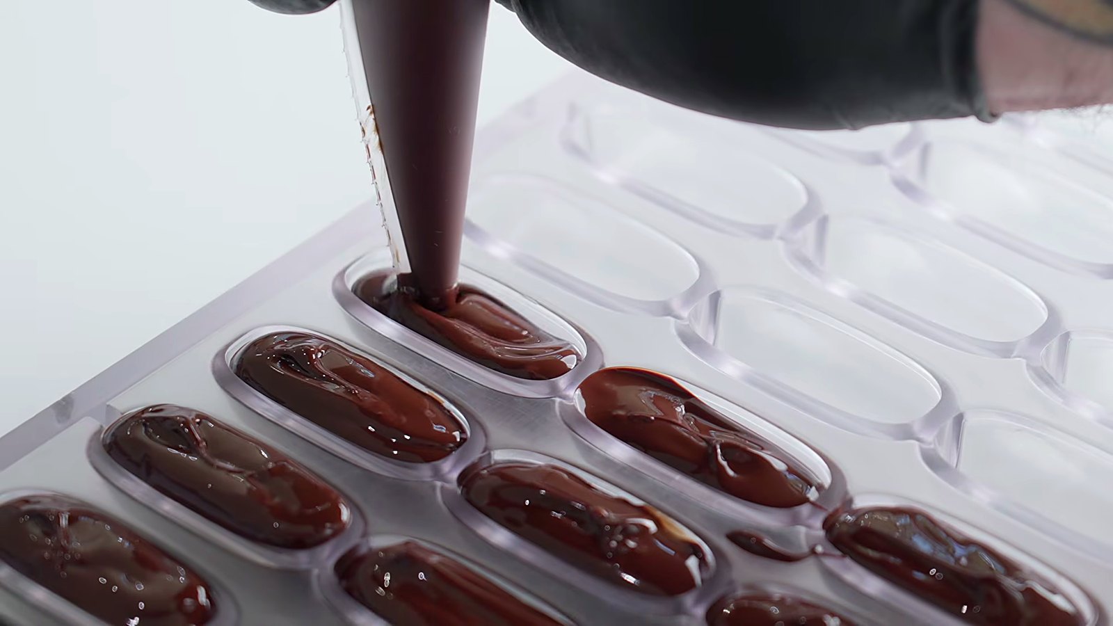 Chocolate piped into moulds.
