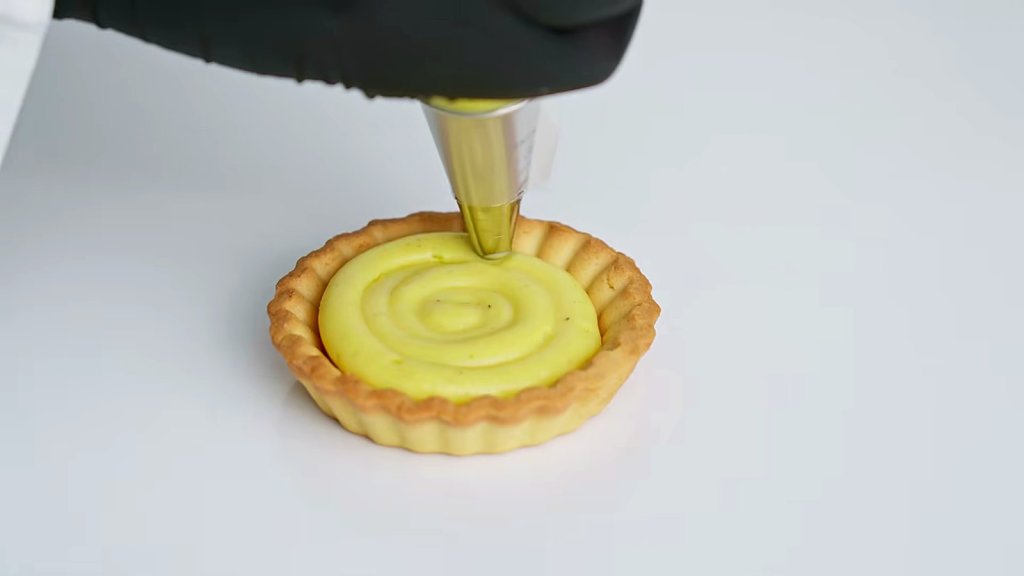 Pastry cream piped into a tart shell