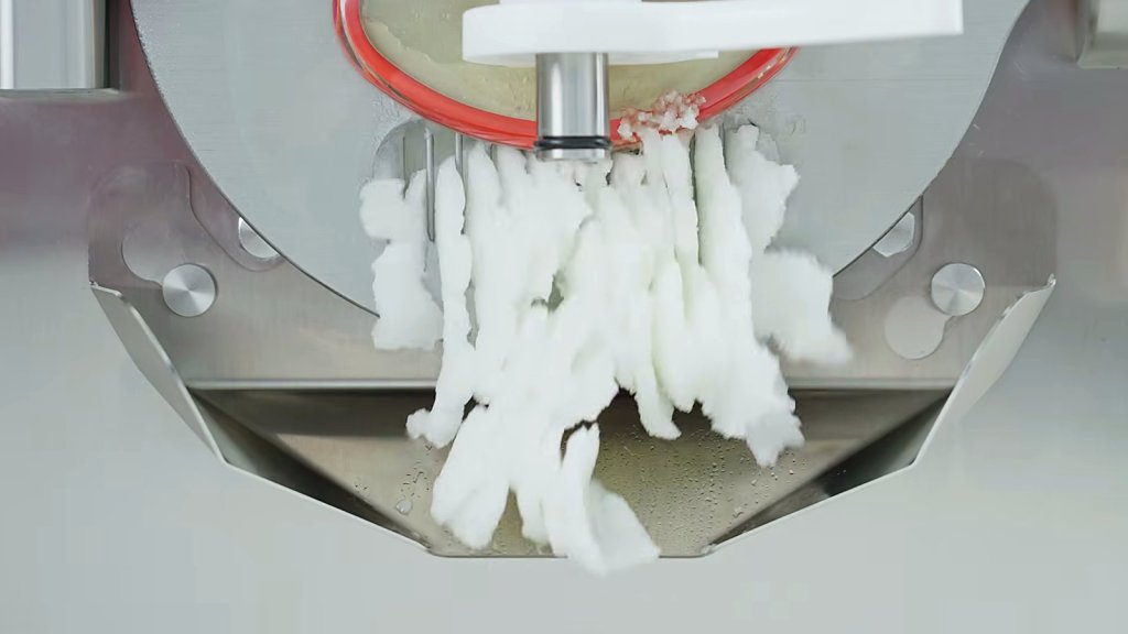 Fior di latte gelato extruding in thick ribbons