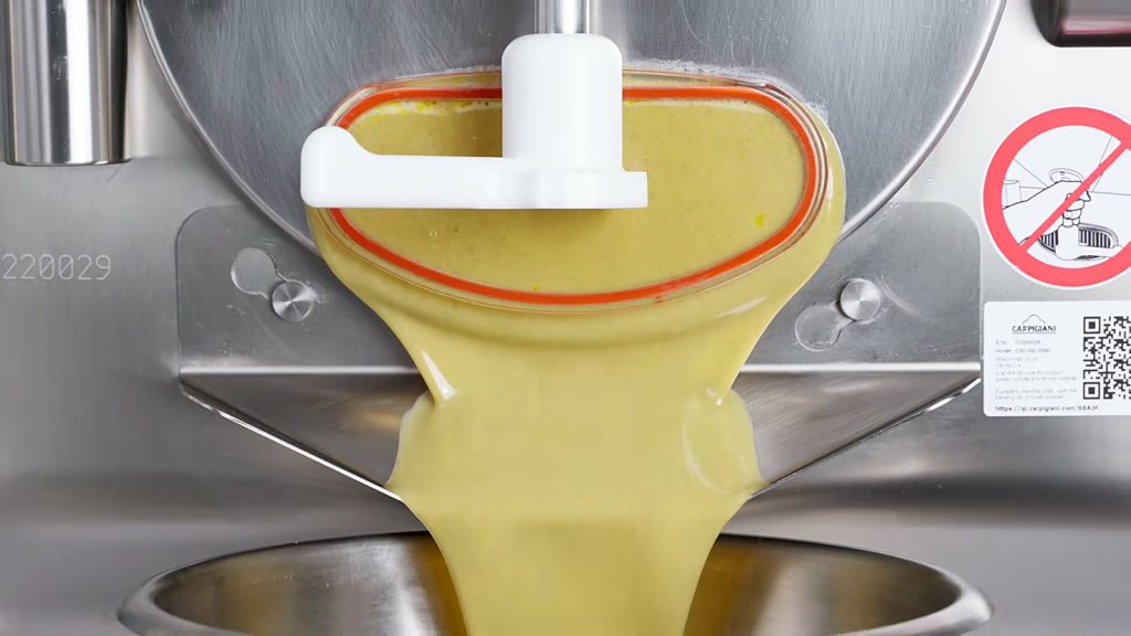 Yellow pastry cream flowing from the machine