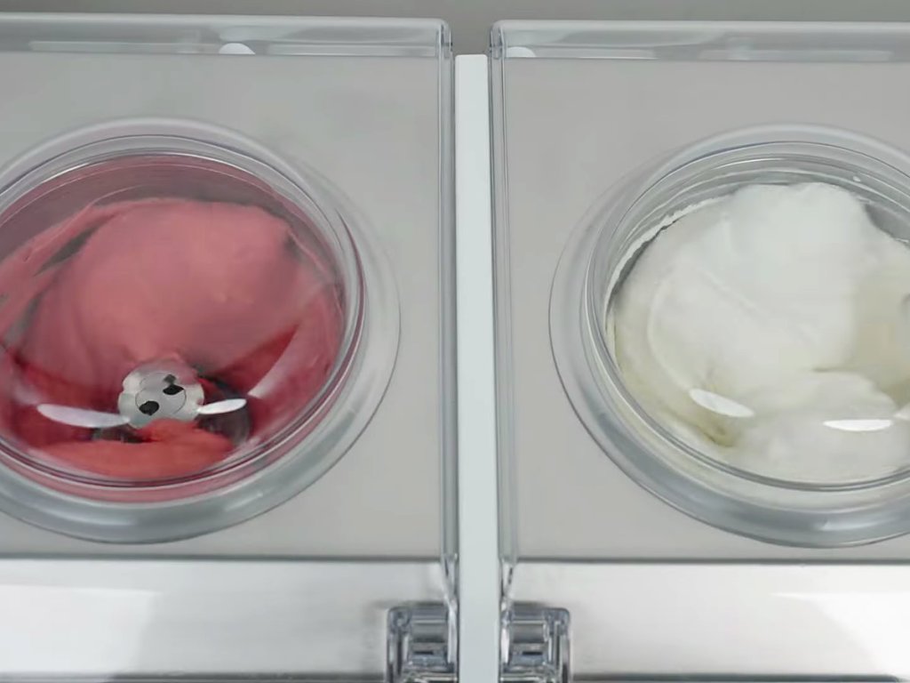 Two cylinders holding strawberry and fior di latte gelato