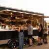 Food van serving customers at an evening event on quiet battery power