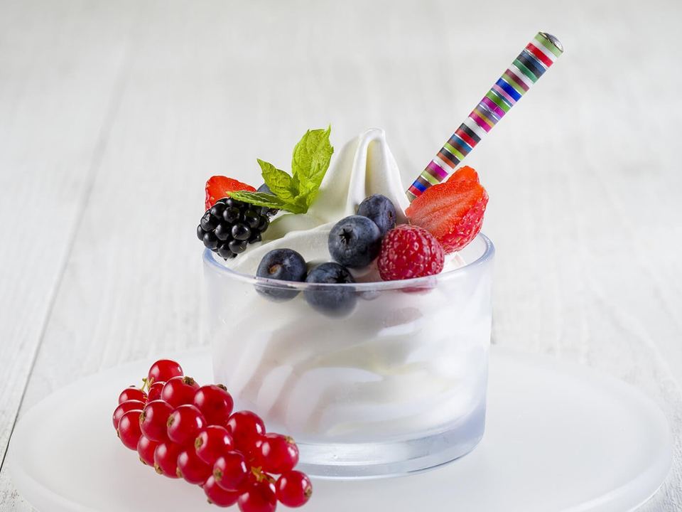 Frozen yoghurt cup topped with fresh berries