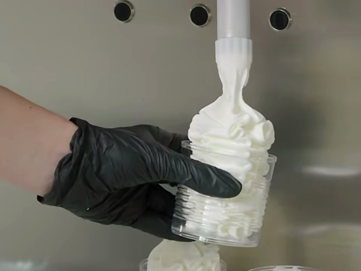 Piping a single serve into a cup.