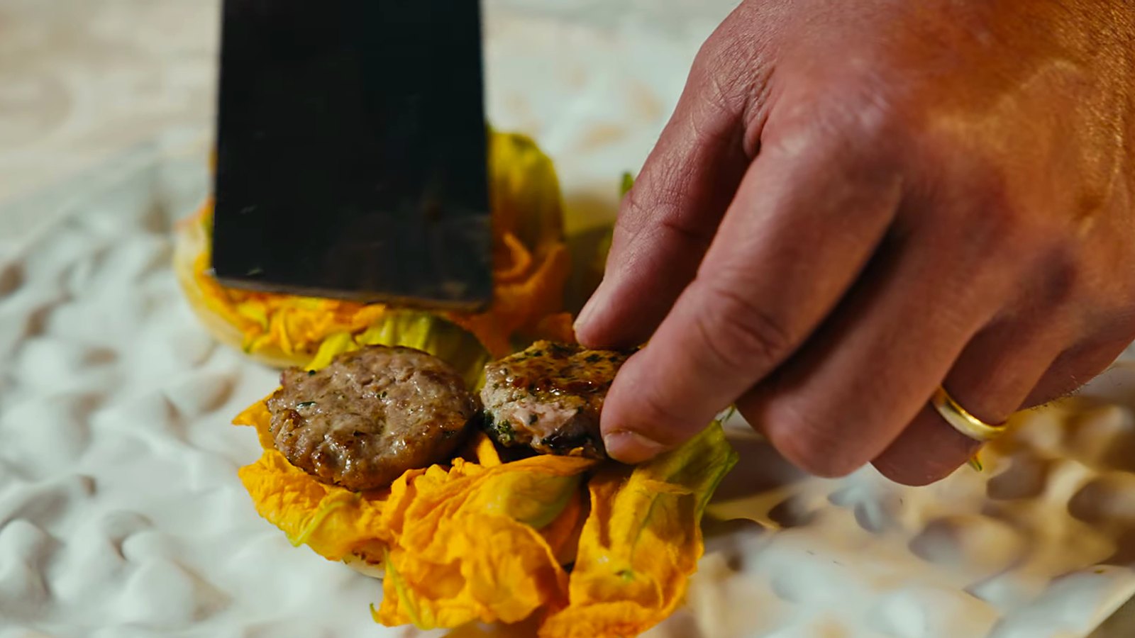 Duck patties placed on courgette flowers.