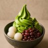 Matcha sundae with mochi and red bean in a ceramic bowl